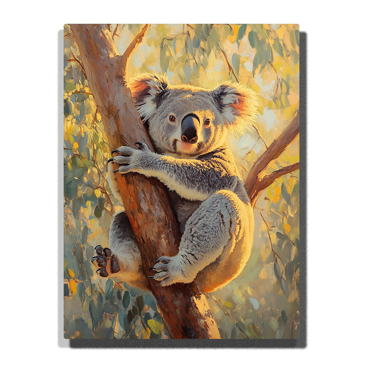 A fluffy koala clinging to a eucalyptus tree trunk, surrounded by soft green leaves and glowing warm sunlight in this PaintEasy Paint by Numbers artwork.