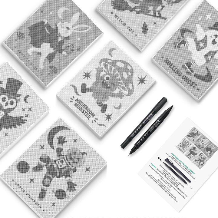 Six black-and-white Halloween creature dot canvases with two double-ended markers