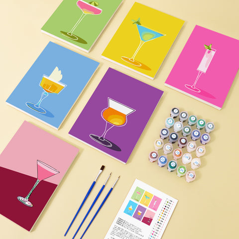 Six mini paint by numbers canvases arranged in a set, each featuring a vibrant cocktail martini glass illustration in different colors including green, yellow, pink, purple, and orange. Each artwork uses a clean flat illustration style with simplified glass shapes, bold color blocking, and smooth gradients in a modern cocktail design theme.