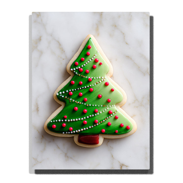 Christmas tree sugar cookie with green icing, red candy ornaments, white pearl garlands, gold sprinkle accents, cream cookie edge, and white marble background, Paint by Numbers kit for kids by PaintEasy.