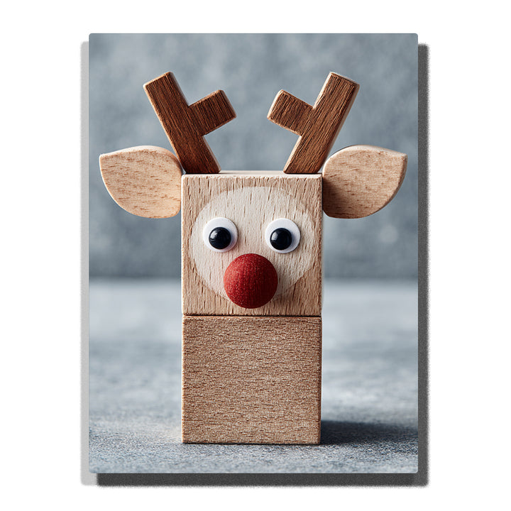 Wooden reindeer block with red nose, googly eyes, brown antlers, rounded wooden ears, visible wood grain, square toy-like body, and soft gray-blue background, Paint by Numbers kit for kids by PaintEasy.