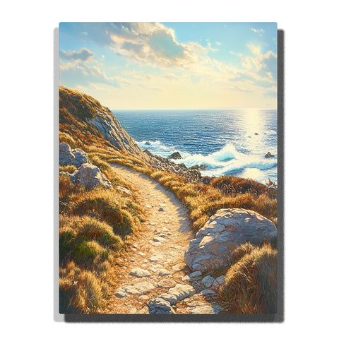 A sunlit coastal path winding through golden grasses and rocks beside bright blue ocean waves under a soft cloud-filled sky in this PaintEasy Paint by Numbers artwork.