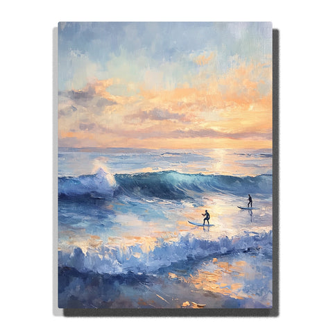 Blue ocean waves with white foam, two surfers in the distance, and a peach-and-gold sunset sky reflected across the water in this PaintEasy Paint by Numbers artwork.