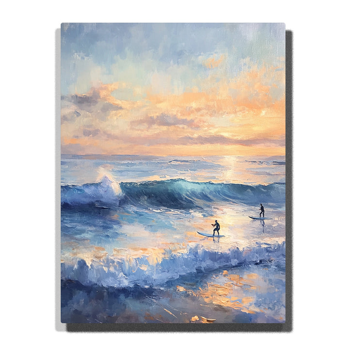 Blue ocean waves with white foam, two surfers in the distance, and a peach-and-gold sunset sky reflected across the water in this PaintEasy Paint by Numbers artwork.