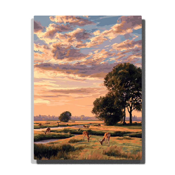 Sunlit meadow deer beneath a peach and lavender cloud sky with open grassland, dark trees, and warm pastoral evening light, landscape paint by numbers wall art by PaintEasy
