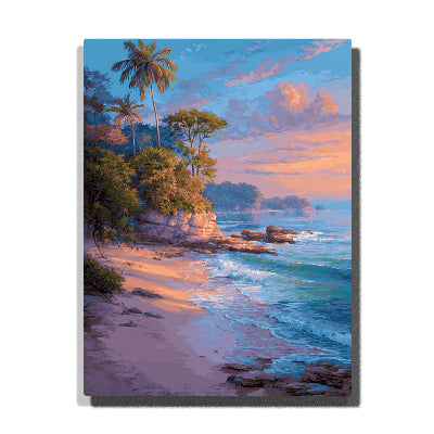 A tropical beach with palm trees, rocky shoreline, and turquoise waves beneath a pink and peach sunset sky in this PaintEasy Paint by Numbers artwork.
