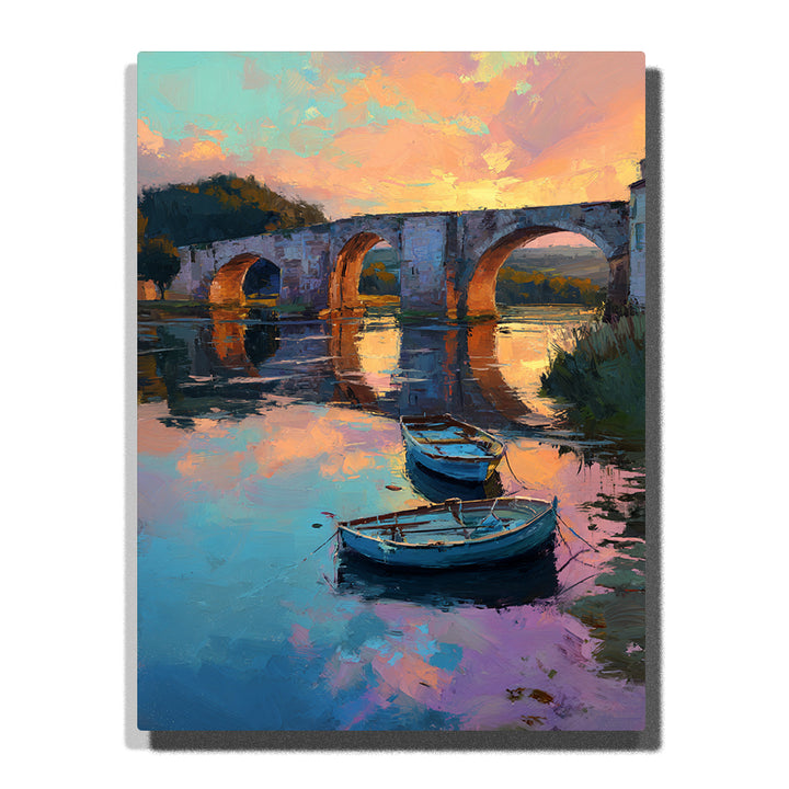 Stone bridge over a quiet river with two moored boats, glowing sunset reflections, and soft pastel water, city paint by numbers wall art by PaintEasy