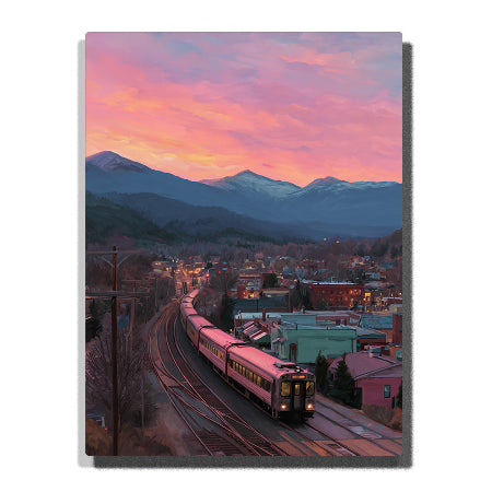 A purple train traveling through a small mountain town on curved tracks beneath a pink and orange sunset sky in this PaintEasy Paint by Numbers artwork.