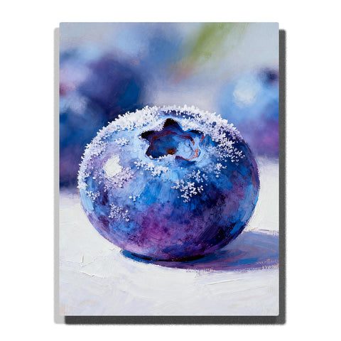 Close-up frosted blueberry on a white tabletop, featuring deep blue and violet tones, pale frost texture, glossy highlights, and a soft blurred background.