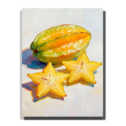 Yellow starfruit with two sliced star-shaped pieces on a white tabletop, featuring glossy green-yellow skin, orange ridges, seed details, and soft shadows.