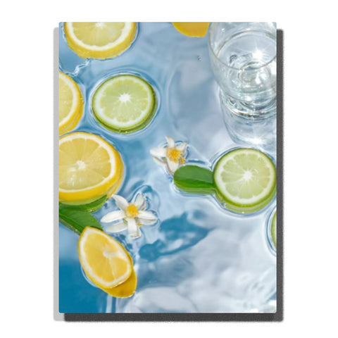 Top-down lemon and lime slices floating in blue water with white blossoms, green leaves, transparent glass, bright reflections, and soft ripples.