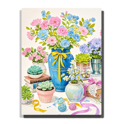 A colorful still-life scene with a blue vase of pink and blue flowers, small succulents, pastel ribbons, and tabletop decor in this Paint by Numbers artwork.