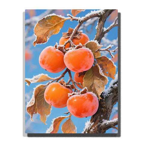 Orange persimmons hanging on a frosted winter branch, featuring brown leaves, snowy twig edges, bright fruit, and a clear blue sky background.