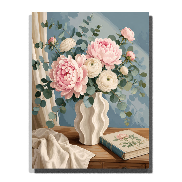 Paint by numbers elegant floral still life featuring soft pink peonies, white ranunculus, and eucalyptus branches arranged in a wavy cream ceramic vase beside a botanical book.