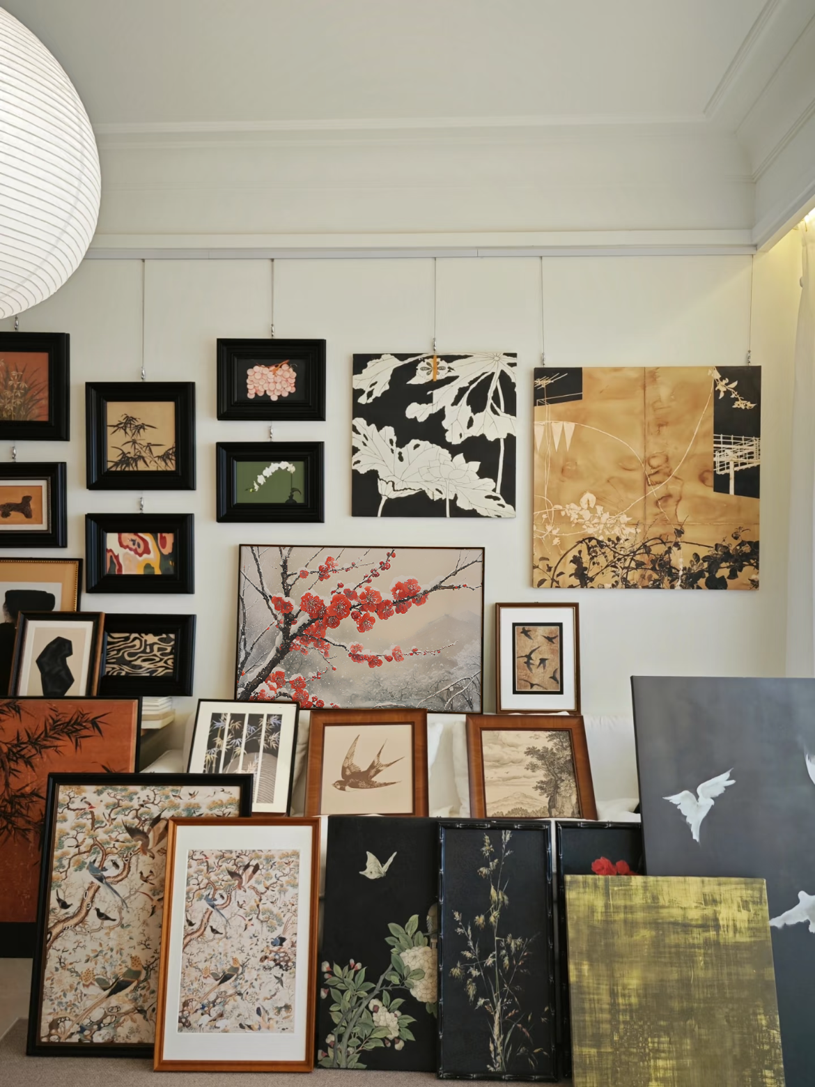 Eclectic framed artwork and canvases arranged as a gallery wall