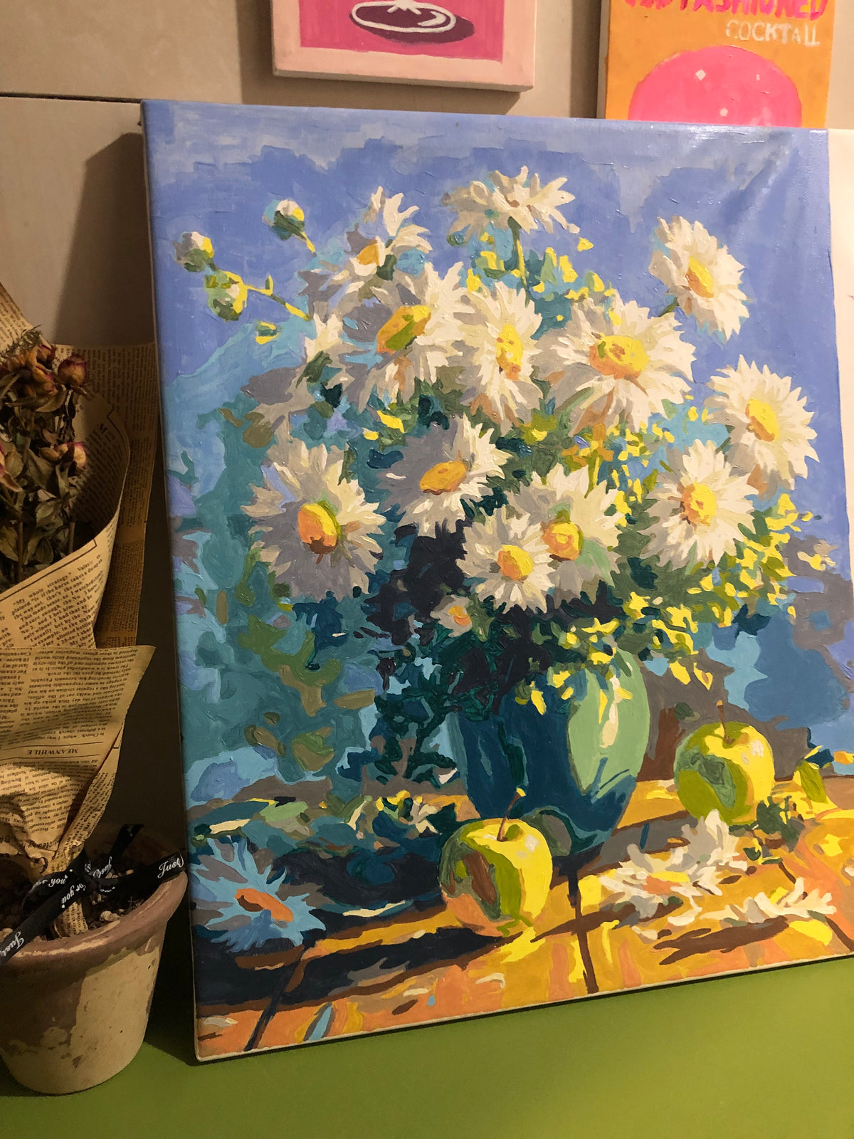 Finished daisy bouquet painting on an easel