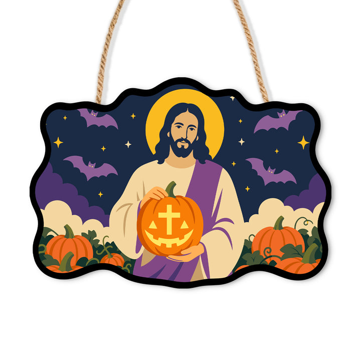 Jesus holding a cross-carved jack-o-lantern beneath bats on a wooden sign