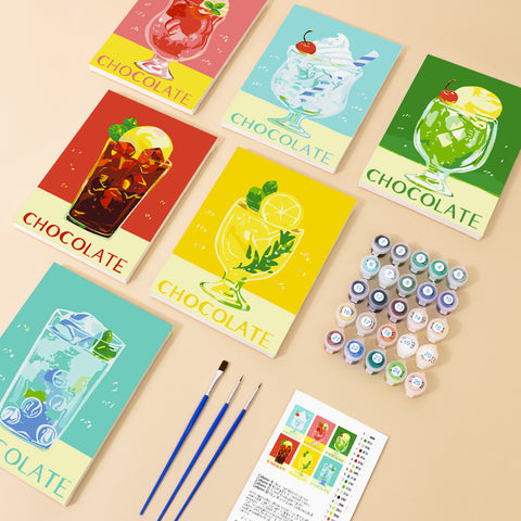 Six mini paint by numbers canvases arranged in a set, each featuring a vibrant chocolate drink illustration including iced chocolate, chocolate floats with whipped cream, chocolate soda, chocolate citrus twist drinks, and mixed chocolate beverages. Each artwork uses a clean flat illustration style with bold colors, simplified glass shapes, and decorative toppings such as cherries, mint leaves, whipped cream, and citrus slices.