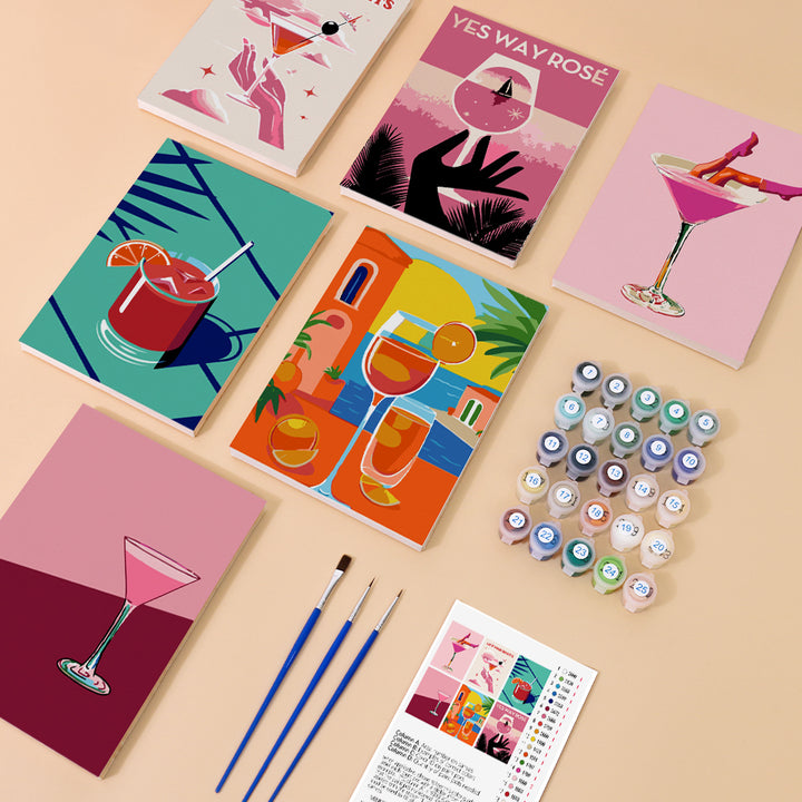 Six mini paint by numbers canvases arranged in a set, each featuring a vibrant cocktail poster-style illustration including pink martini drinks, tropical cocktails, citrus spritz beverages, sunset-themed glasses, and abstract cocktail designs, all created in a bold flat poster style with strong colors and simplified graphic shapes.