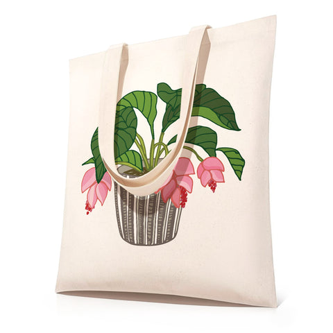 DIY floral plant paint by numbers tote bag kit featuring a canvas shopping bag with potted indoor plant illustration, showing before-and-after transformation from outline sketch to fully colored green leaves and pink flowers botanical design.