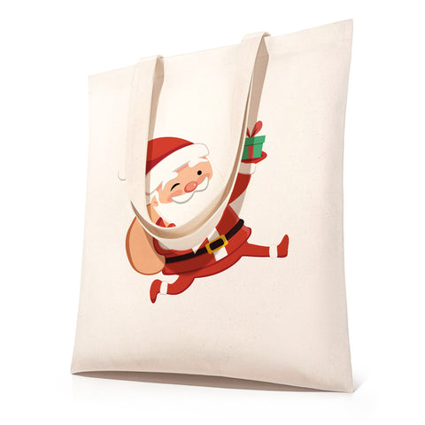 DIY Christmas Santa paint by numbers tote bag kit featuring a canvas shopping bag with pre-printed Santa Claus holding a gift, shown in before-and-after transformation from outline sketch to fully colored festive Christmas tote bag.