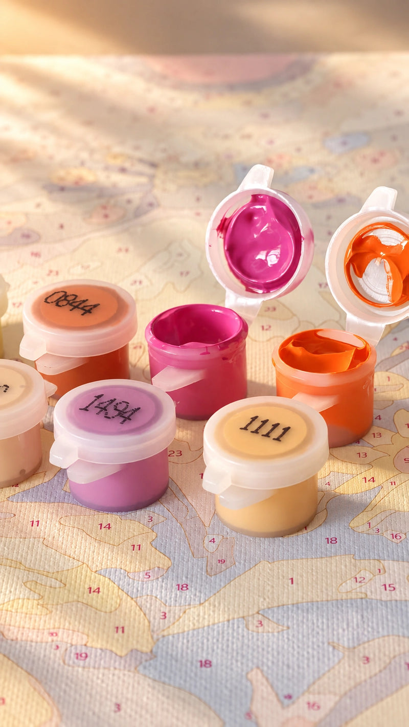 Close-up of open acrylic paint pots — shared PaintEasy kit example